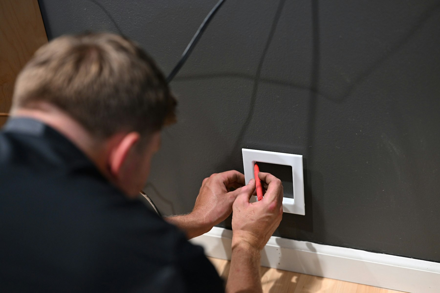 Technician repairing a wall light switch