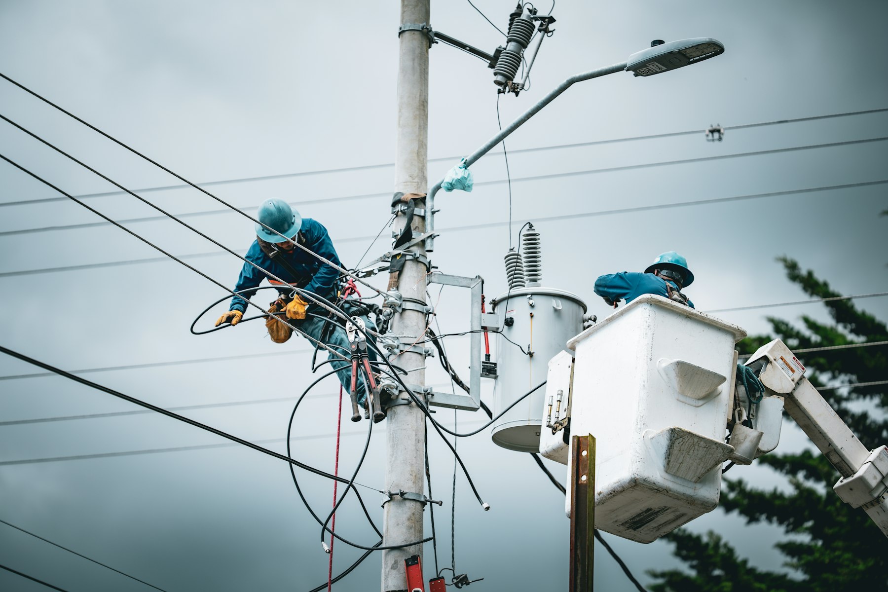 Linemen working on a utility pole from a bucket truck