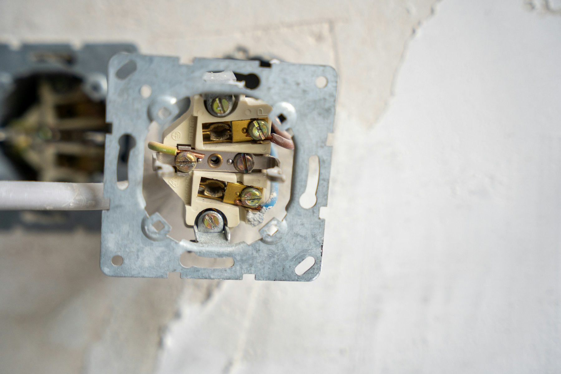 Electrical outlet opened up showing its wiring