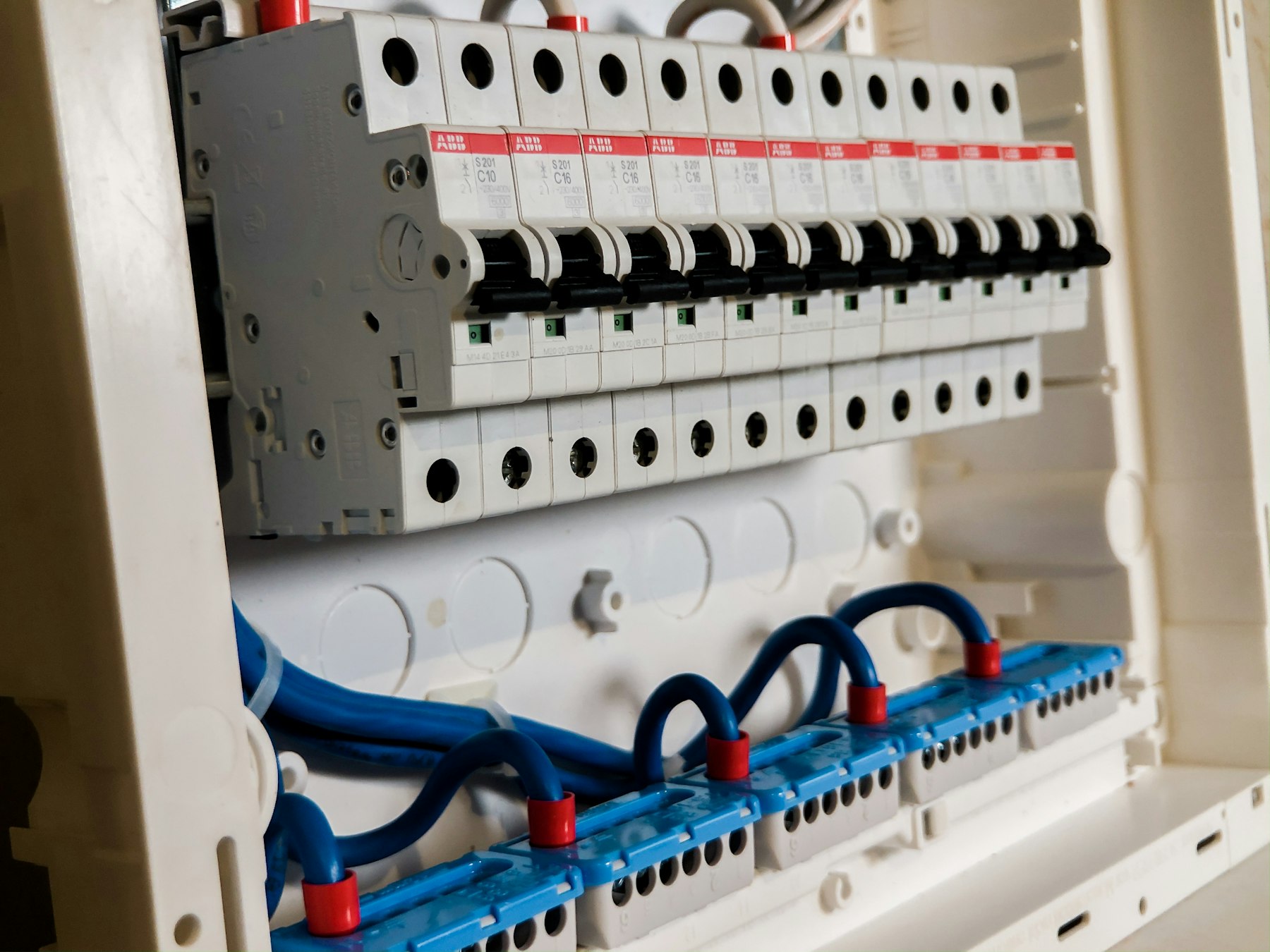 Row of white circuit breakers in a consumer unit